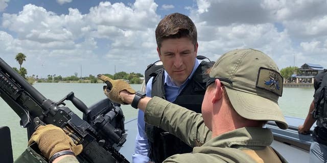 House Select Committee on Economic Disparity and Fairness in Growth Ranking Member Bryan Stiel, R-Wis., speaks with a Texas Department of Public Safety trooper on a boat patrolling the Rio Grande on June 17, 2022. 