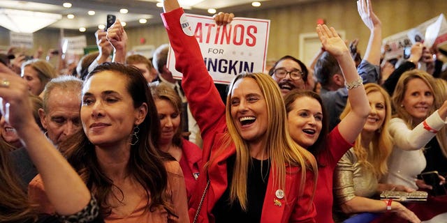 Hispanic supporters of Republican nominee for Governor of Virginia, Glenn Youngkin, react as Fox News declares Youngkin has won his race against Democratic Governor Terry McAuliffe and Youngkin will be the next Governor of Virginia during an election night party at a hotel in Chantilly, Virginia, U.S., November 3, 2021.