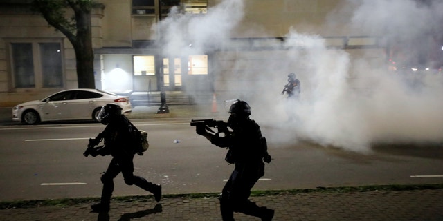 Riot police run at protesters while firing tear gas during nationwide unrest following the death in Minneapolis police custody of George Floyd, in Raleigh, North Carolina, U.S. May 31, 2020.