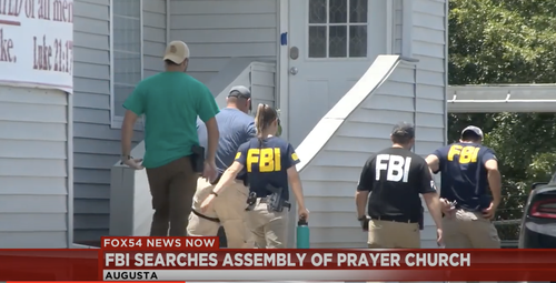 Agents with "FBI" emblazoned on their shirts outside the Assembly of Prayer Church near Augusta Georgia