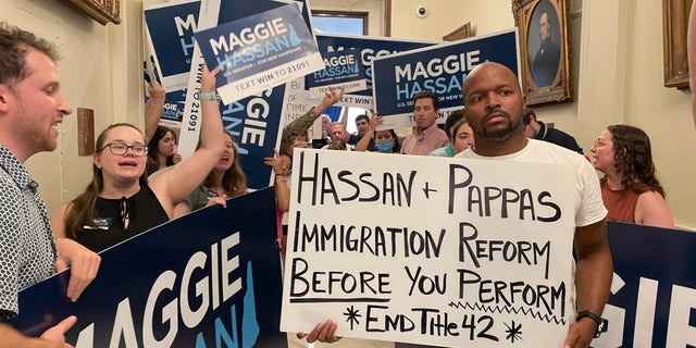 Immigration activists protesting Sen. Maggie Hassan's border security stance are outnumbered by Hassan supporters as the Democratic senator from New Hampshire arrives at the State House to file for re-election, on June 10, 2022 in Concord, N.H.
