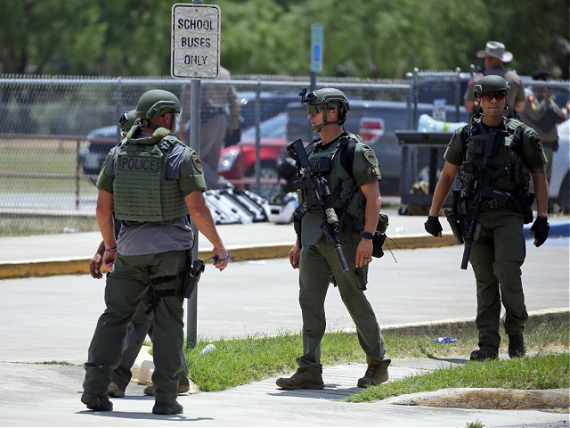 Law enforcement personnel stand outside Robb Elementary School following a shooting, Tuesday, May 24, 2022, in Uvalde, Texas. (AP Photo/Dario Lopez-Mills)