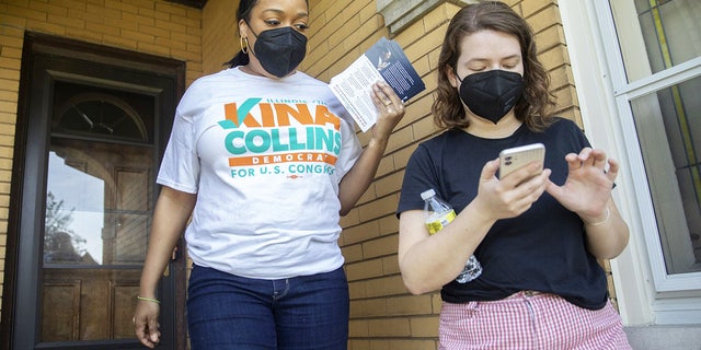 Challenger Kina Collins, left, campaigns door-to-door with her manager, Isabel Alter, on May 29, 2022, in Chicago&amp;apos;s Galewood neighborhood. (Erin Hooley/Chicago Tribune/Tribune News Service via Getty Images)
