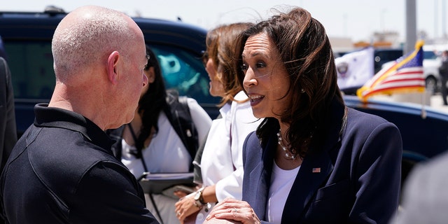 U.S. Vice President Kamala Harris speaks with Alejandro Mayorkas, secretary of the U.S. Department of Homeland Security, before boarding Air Force Two at the El Paso International Airport in El Paso, Texas, on Friday, June 25, 2021.