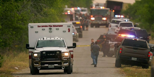 An ambulance leaves the scene where police said dozens of people were found dead in a semitrailer in a remote area in southwestern San Antonio, Monday, June 27, 2022.