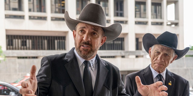 Otero County, New Mexico Commissioner Couy Griffin speaks to reporters as he arrives at federal court in Washington, Friday, June. 17, 2022. Griffin, who is a central figure in a New Mexico county’s refusal to certify recent election results based on debunked conspiracy theories about voting machines, has avoided more jail time for joining the mob that attacked the U.S. Capitol. He was sentenced to 14 days behind bars, which he has already served. (AP Photo/Gemunu Amarasinghe)