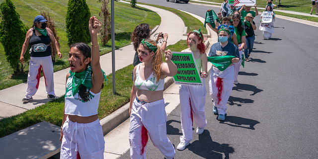 Abortion-rights activists with Rise Up 4 Abortion Rights chant after marching to the home of Supreme Court Justice Amy Coney Barrett on June 18, 2022 in Falls Church, Virginia. 