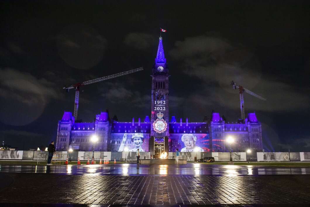 Purple light and images of Queen Elizabeth II are projected onto Parliament Hill's Centre Block to mark the queen's Platinum Jubilee in Ottawa, Ontario, on Thursday.