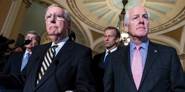 Sen. Mitch McConnell, R-Ky., left, and Sen. John Cornyn, R-Texas, right, talk to reporters following a closed-door policy meeting at the Capitol in Washington, Tuesday, March 8, 2016. 