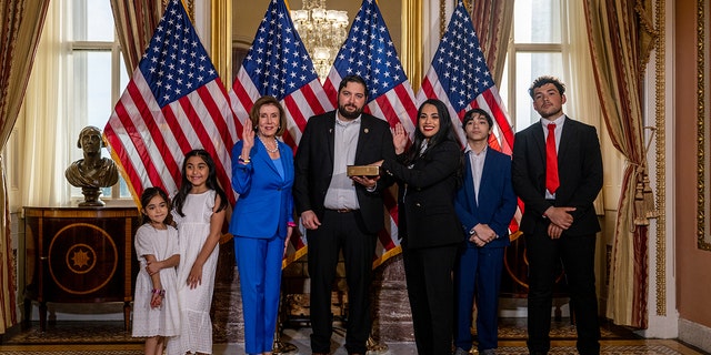 Rep. Mayra Flores (R-TX) stands with her family and Speaker of the House Nancy Pelosi (D-CA) for a portrait after being sworn-in on June 21, 2022 in Washington, D.C. 