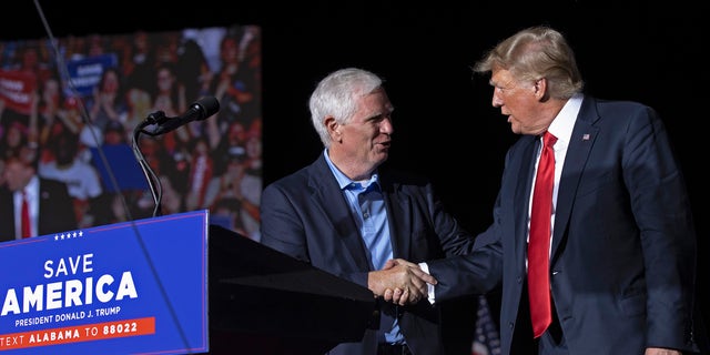 FILE - Former U.S. President Donald Trump welcomes candidate for U.S. Senate and U.S. Rep. Mo Brooks, R-Ala., to the stage during a "Save America" rally at York Family Farms on Aug. 21, 2021 in Cullman, Alabama. 