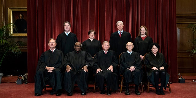 Members of the Supreme Court pose for a group photo on April 23, 2021. They are, seated from left, Justices Samuel Alito and Clarence Thomas, Chief Justice John Roberts, and Justices Stephen Breyer and Sonia Sotomayor, and, standing from left, Justices Brett Kavanaugh, Elena Kagan, Neil Gorsuch and Amy Coney Barrett.