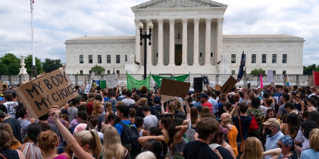 Abortion-rights protesters gather outside the Supreme Court in Washington, Friday, June 24, 2022. The Supreme Court has ended constitutional protections for abortion that had been in place nearly 50 years, a decision by its conservative majority to overturn the court's landmark abortion cases. 