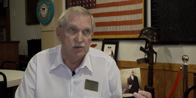 Dave Giles, a candidate in the Republican primary for Arizona's 4th District, waves a pocket Constitution.