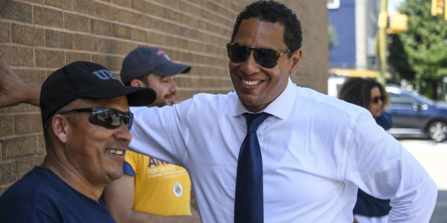 Candidate for Baltimore City States Attorney Ivan Bates shares a laugh with members of his team outside the William Pace Elementary voting location on Tuesday. 