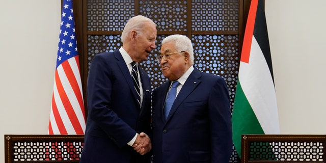 Palestinian President Mahmoud Abbas and U.S. President Joe Biden shake hands in the West Bank town of Bethlehem, Friday, July 15, 2022. 