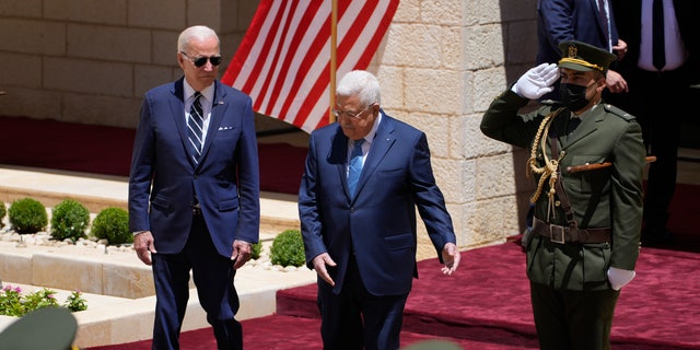 U.S. President Joe Biden and Palestinian President Mahmoud Abbas review the guard of honor during a welcoming ceremony prior to their meeting at the West Bank town of Bethlehem, Friday, July 15, 2022. (AP Photo/Majdi Mohammed)