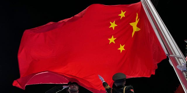 The Chinese flag is raised during the opening ceremony of the 2022 Winter Olympics.