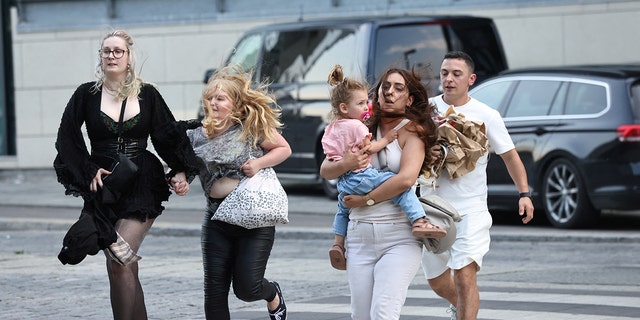 People leave Field's shopping centre, after Danish police said they received reports of shooting, in Copenhagen, Denmark, July 3, 2022. 