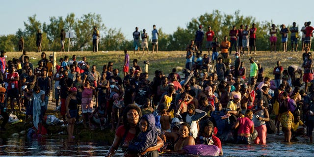 TOPSHOT - Haitian migrants continue to cross the US-Mexico border on the Rio Grande, as seen from Ciudad Acuna, Coahuila state, Mexico on September 20, 2021. (Photo by PAUL RATJE / AFP)