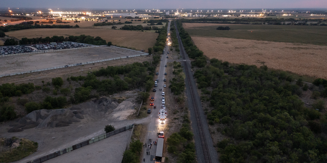 In this aerial view, members of law enforcement investigate a tractor trailer on June 27, 2022, in San Antonio, Texas. According to reports, at least 46 people, who are believed migrant workers from Mexico, were found dead in an abandoned tractor trailer. Over a dozen victims were found alive, suffering from heat stroke and taken to local hospitals. (Photo by 