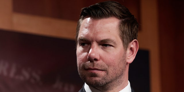 Rep. Eric Swalwell, D-Calif., listens as Sen. Jack Reed, D-R.I., speaks during a news conference on the introduction of their Protection from Abusive Passengers Act at the U.S. Capitol Building on April 6, 2022, in Washington.