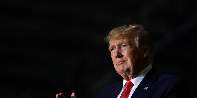 Former U.S. President Donald Trump claps as the crowd cheers him on during a rally in Washington Township, Michigan, U.S. April 2, 2022.