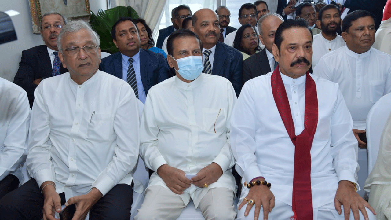 Lawmaker Lakshman Kiriella, left, former President Maithripala Sirisena, center and former Prime Minister Mahinda Rajapaksa attend the swearing-in ceremony of Sri Lanka's newly elected President Ranil Wickremesinghe, in Colombo, July 21, 2022.