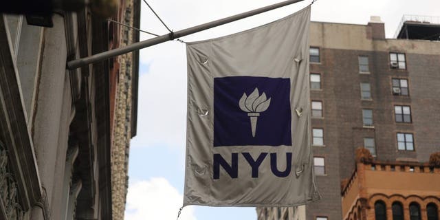 A New York University (NYU) flag flies outside a Covid-19 test tent outside of the NYU business school on August 25, 2020 in New York City.