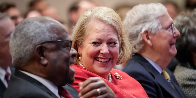 Associate Supreme Court Justice Clarence Thomas sits with his wife and conservative activist Virginia Thomas while he waits to speak at the Heritage Foundation on October 21, 2021, in Washington, DC. 