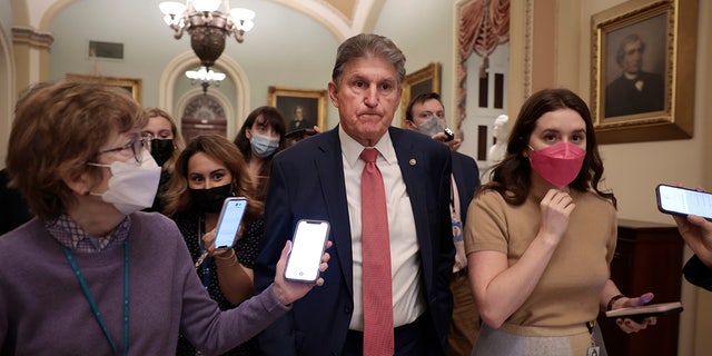 Joe Manchin, D-W.Va., is followed by reporters as he leaves a caucus meeting with Senate Democrats at the U.S. Capitol Dec. 17, 2021.