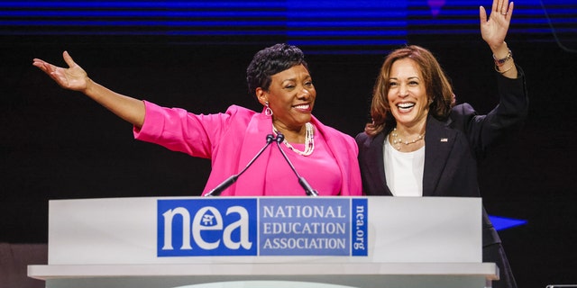 U.S. Vice President Kamala Harris, right, waves with Becky Pringle, president of the National Education Association, at the National Education Association 2022 annual meeting and representative assembly in Chicago July 5, 2022. 