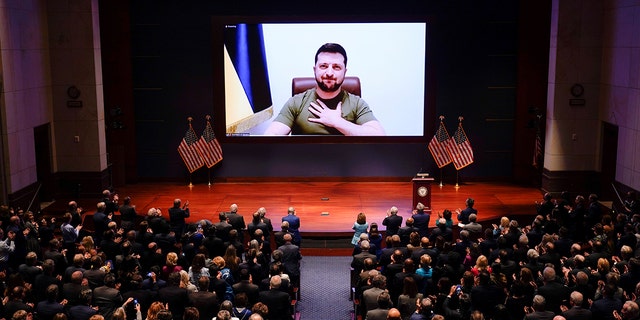 Ukrainian President Volodymyr Zelensky is seen on the screen delivering a speech via videoconference to the U.S. Congress at the Capitol in Washington, D.C., the United States, March 16, 2022. (J. Scott Applewhite/Pool via Xinhua)