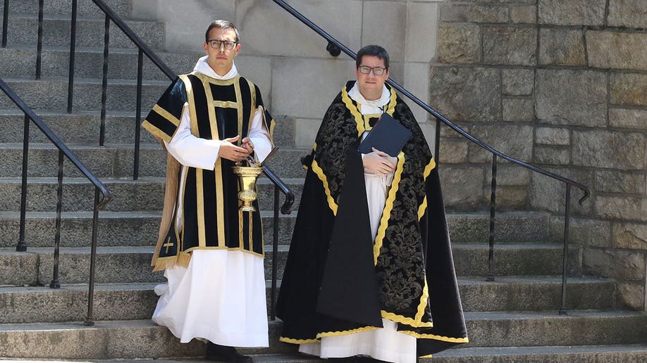 Clergy outside church Trump funeral