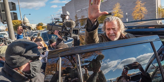 Steve Bannon, former adviser to Donald Trump, waves to members of the media as he departs federal court in Washington, D.C., on Monday, Nov. 15, 2021. 