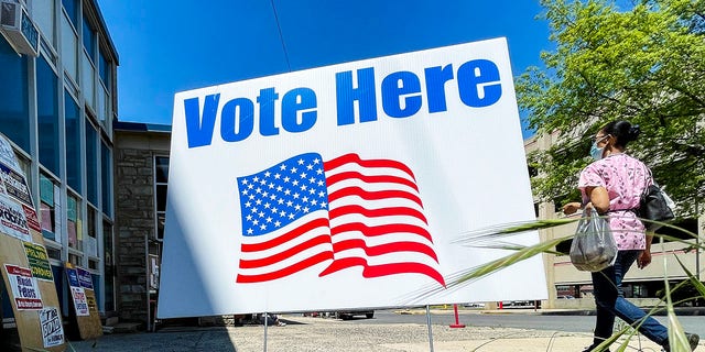 A "Vote Here" sign outside the polling place setup in the 3rd and Court Fire Station in Reading, Pennsylvania, on May 18, 2021.