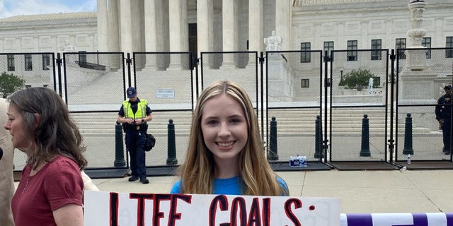 A woman holds a sign celebrating the Supreme Court's ruling to overturn Roe vs. Wade.