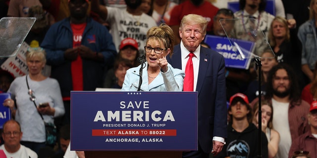 Republican U.S. House  candidate former Alaska Gov. Sarah Palin (L) speaks as former U.S. President Donald Trump (R) looks on during a "Save America" rally at Alaska Airlines Center on July 09, 2022 in Anchorage, Alaska. 