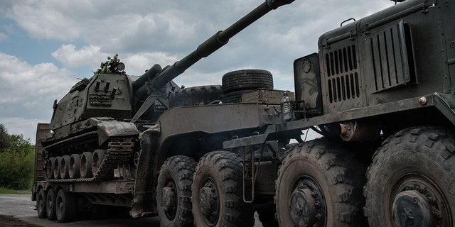 This photograph taken May 10, 2022, shows the Ukrainian Army's self-propelled howitzer loading on a tank transporter near Bakhmut, eastern Ukraine, amid the Russian invasion of Ukraine. 