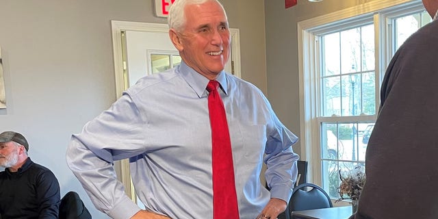 Former Vice President Mike Pence, during a trip to New Hampshire, greets customers at Simply Delicious Bakery in Bedford, N.H., on Dec. 8, 2021