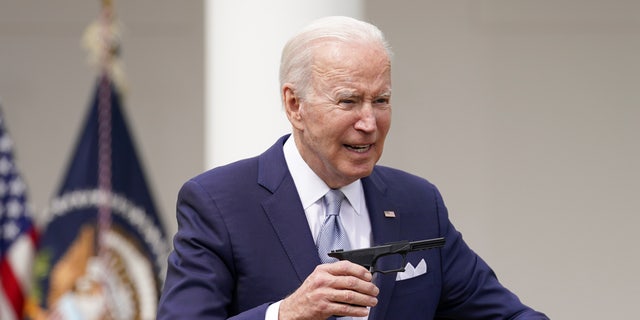 U.S. President Joe Biden holds up a ghost gun kit while announcing new measures by his administration to fight ghost gun crime at the White House in, Washington, U.S., April 11, 2022. 