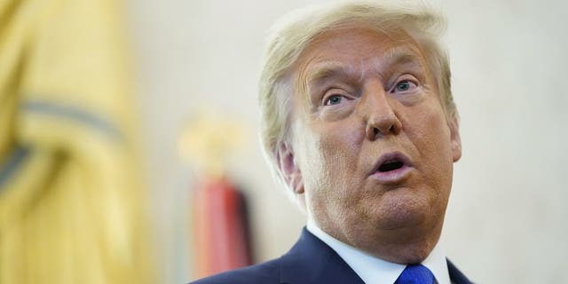 Then-President Donald Trump speaks after awarding the Presidential Medal of Freedom to Olympic gold medalist and former University of Iowa wrestling coach Dan Gable at the White House on Dec. 7, 2020, in Washington, D.C.