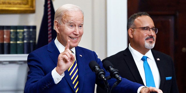 US President Joe Biden announces student loan relief with Education Secretary Miguel Cardona (R) on August 24, 2022 in the Roosevelt Room of the White House in Washington, DC. - Biden announced that most US university graduates still trying to pay off student loans will get $10,000 of relief to address a decades-old headache of massive educational debt across the country.