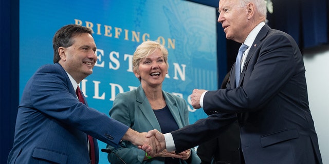 President Biden, right, shakes hands with White House chief of staff Ron Klain alongside Secretary of Energy Jennifer Granholm at the Eisenhower Executive Office Building in Washington on June 30, 2021.