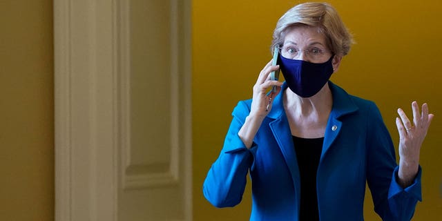 U.S. Senator Elizabeth Warren (D-MA) talks on the phone before the start of the Senate Democrats weekly policy lunch at the U.S. Capitol building in Washington, U.S., December 14, 2021.