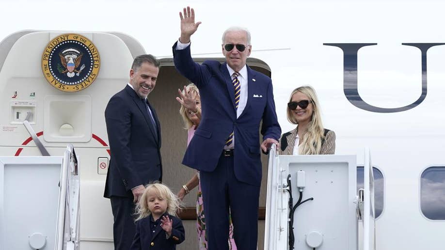 President Joe Biden waves to reporters