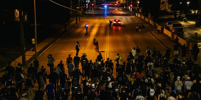Demonstrators march in the streets on August 26, 2020 in Kenosha, Wisconsin. After the city declared a state of emergency curfew, a fourth night of civil unrest occurred after the shooting of Jacob Blake, 29, on August 23.