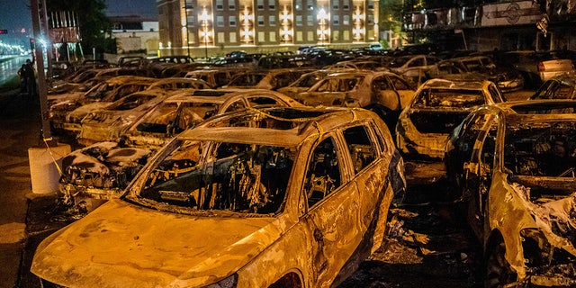 The carcasses of the cars burned by protestors the previous night during a demonstration against the shooting of Jacob Blake are seen on a used-cars lot in Kenosha, Wisconsin on August 26, 2020.
