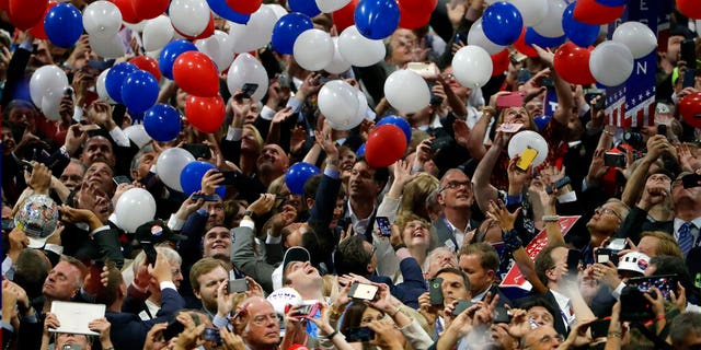 In this July 21, 2016, file photo, confetti and balloons fall during celebrations after then-Republican presidential nominee Donald Trump's acceptance speech on the final day of the Republican National Convention in Cleveland, Ohio.