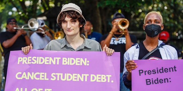 Student loan debt holders take part in a demonstration outside the White House staff entrance to demand that President Biden cancel student loan debt on July 27, 2022 at the Executive Offices in Washington, D.C.